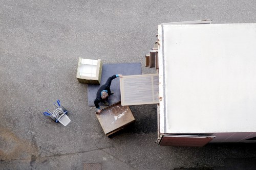 A moving team handling boxes on a North London residential street